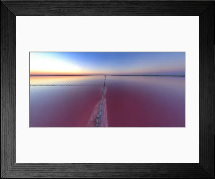 Framed Print : Top view of a shiny salty pink lake and a path along it Framed Print : Top view of a shiny salty pink lake and a path along it