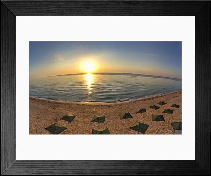 Framed Print : Beach umbrellas at sunrise. Sea current swims against the waves on the beautiful sea Framed Print : Beach umbrellas at sunrise. Sea current swims against the waves on the beautiful sea