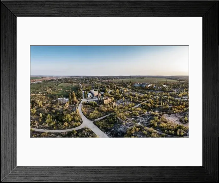 Framed Print : Extraction of minerals with the help of special equipment near a small lake in the warm evening light in picturesque Framed Print : Extraction of minerals with the help of special equipment near a small lake in the warm evening light in picturesque