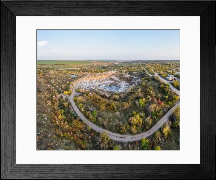 Framed Print : Extraction of minerals with the help of special equipment near a small lake in the warm evening light in picturesque Framed Print : Extraction of minerals with the help of special equipment near a small lake in the warm evening light in picturesque