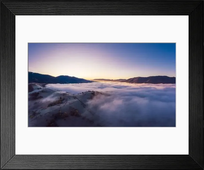 Framed Print : Sunrise over mountain hils covered with gray mist. Aerial panoramic drone shot Framed Print : Sunrise over mountain hils covered with gray mist. Aerial panoramic drone shot