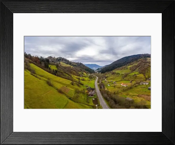 Framed Print : Small village in a mountain valley of the Carpathian Mountains on an autumn day in Ukraine along a road Framed Print : Small village in a mountain valley of the Carpathian Mountains on an autumn day in Ukraine along a road