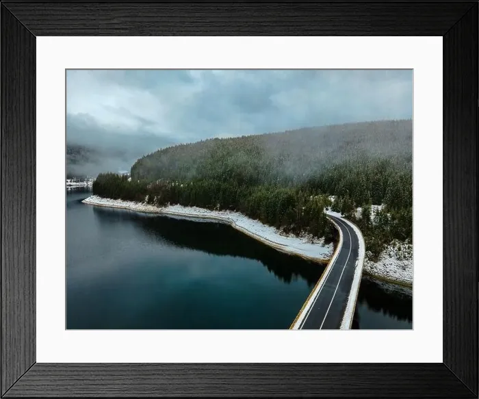 Framed Print : Drone photography from a high altitude of a road and a bridge crossing a mountain lake Framed Print : Drone photography from a high altitude of a road and a bridge crossing a mountain lake