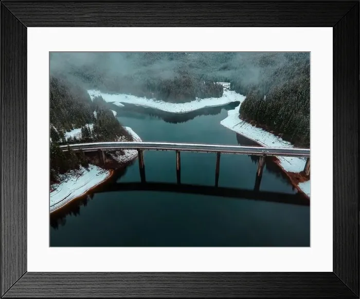 Framed Print : Drone photography from a high altitude of a road and a bridge crossing a mountain lake Framed Print : Drone photography from a high altitude of a road and a bridge crossing a mountain lake