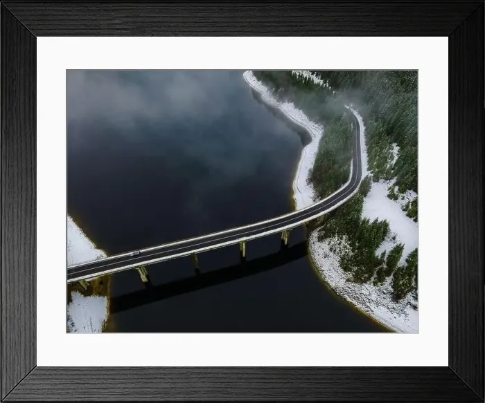 Framed Print : Drone photography from a high altitude of a road and a bridge crossing a mountain lake Framed Print : Drone photography from a high altitude of a road and a bridge crossing a mountain lake