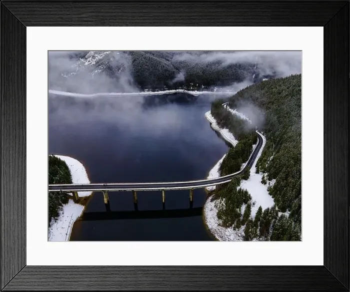 Framed Print : Drone photography from a high altitude of a road and a bridge crossing a mountain lake