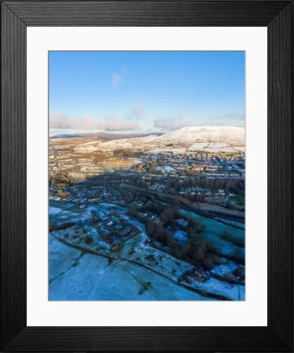 Framed Print : Aerial drone view of snow covered mountains and towns rising above the south east valleys, Wales Framed Print : Aerial drone view of snow covered mountains and towns rising above the south east valleys, Wales