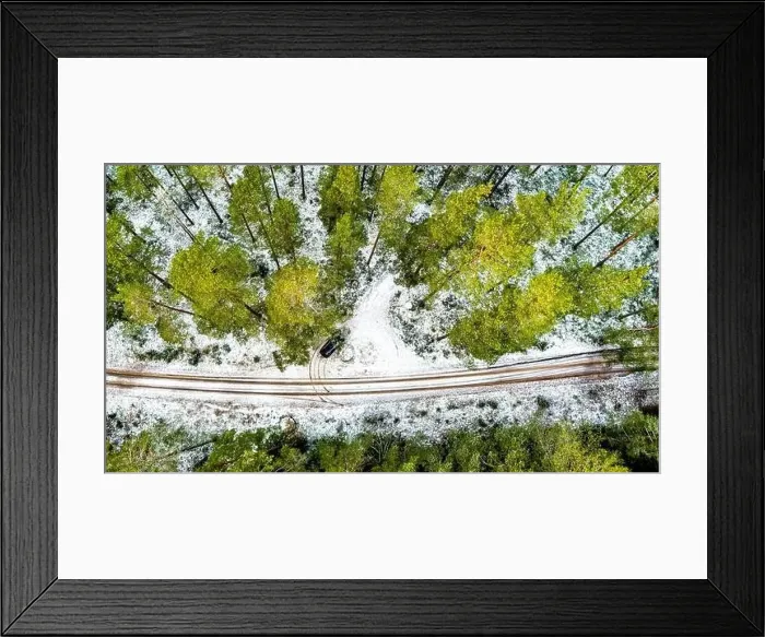 Framed Print : Aerial View Of Black Car On Snow Covered forest road Framed Print : Aerial View Of Black Car On Snow Covered forest road