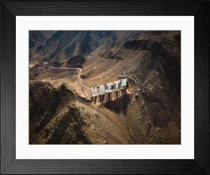 Framed Print : Hatta city welcoming sign written with large letters placed in Hajar mountains in Hatta enclave of Dubai in the United Framed Print : Hatta city welcoming sign written with large letters placed in Hajar mountains in Hatta enclave of Dubai in the United