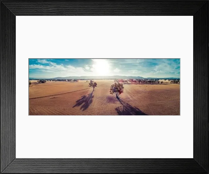 Framed Print : Wide aerial panorama of sunset over fields in Australian outback with lens flare