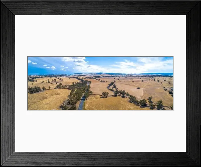 Framed Print : Winding road and small creek passing through agricultural land on a sunny day in Victoria, Australia - aerial panorama Framed Print : Winding road and small creek passing through agricultural land on a sunny day in Victoria, Australia - aerial panorama