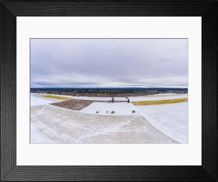 Framed Print : Wide winter aerial view over snowy fields with trees and a cloudy horizon, shot by a drone Framed Print : Wide winter aerial view over snowy fields with trees and a cloudy horizon, shot by a drone