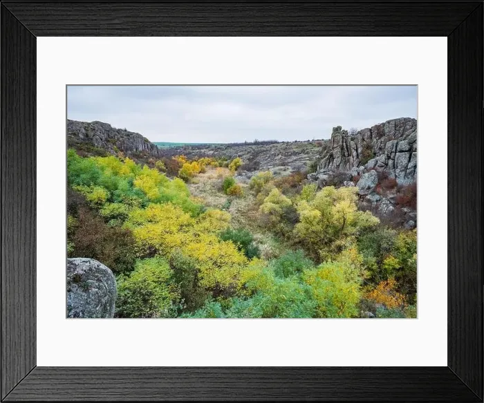 Framed Print : Aktovsky Canyon, Ukraine. Autumn trees and large stone boulders around Framed Print : Aktovsky Canyon, Ukraine. Autumn trees and large stone boulders around