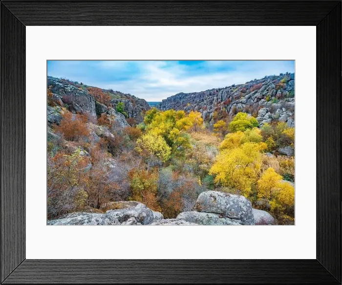 Framed Print : Aktovsky Canyon, Ukraine. Autumn trees and large stone boulders around Framed Print : Aktovsky Canyon, Ukraine. Autumn trees and large stone boulders around