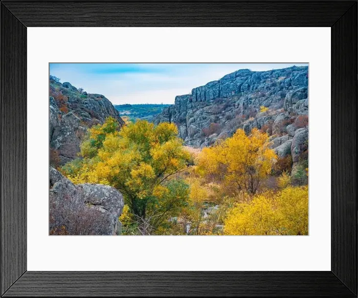 Framed Print : Aktovsky Canyon, Ukraine. Autumn trees and large stone boulders around Framed Print : Aktovsky Canyon, Ukraine. Autumn trees and large stone boulders around