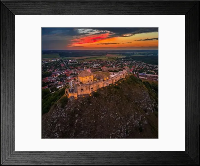 Framed Print : Sumeg, Hungary - Aerial view of the famous illuminated High Castle of Sumeg in Veszprem county at sunset with colorful Framed Print : Sumeg, Hungary - Aerial view of the famous illuminated High Castle of Sumeg in Veszprem county at sunset with colorful