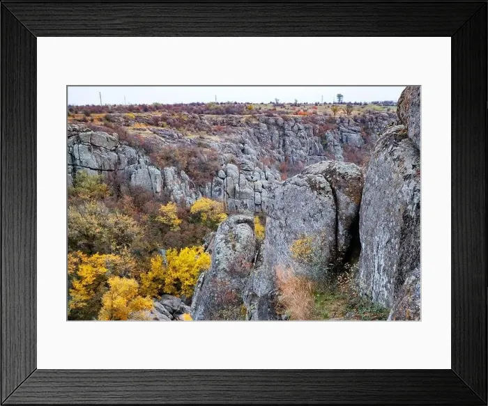 Framed Print : Aktovsky Canyon, Ukraine. Autumn trees and large stone boulders around Framed Print : Aktovsky Canyon, Ukraine. Autumn trees and large stone boulders around
