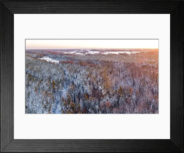 Framed Print : Snow covered winter forest view from drone during sunrise Framed Print : Snow covered winter forest view from drone during sunrise