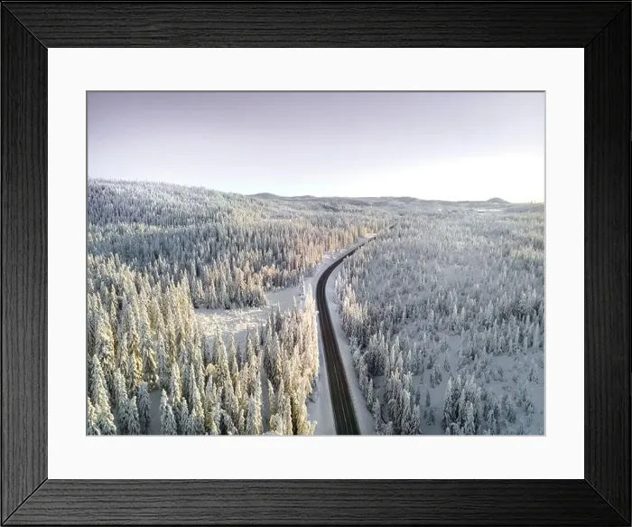 Framed Print : Highway with cars driving through a mountain pass with snow covered trees Framed Print : Highway with cars driving through a mountain pass with snow covered trees