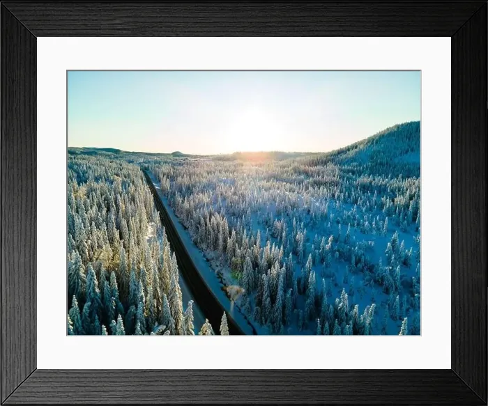 Framed Print : Highway with cars driving through a mountain pass with snow covered trees Framed Print : Highway with cars driving through a mountain pass with snow covered trees