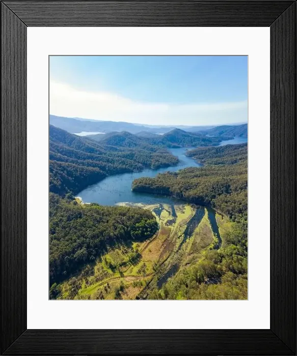 Framed Print : Picturesque drone view of green vegetation washing by river water against sunset sky in countryside in Australia Framed Print : Picturesque drone view of green vegetation washing by river water against sunset sky in countryside in Australia