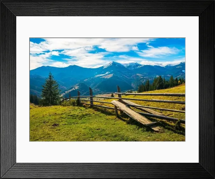 Framed Print : Bewitching beautiful summer landscape of a green meadow on a hill overlooking a dense coniferous forest Framed Print : Bewitching beautiful summer landscape of a green meadow on a hill overlooking a dense coniferous forest