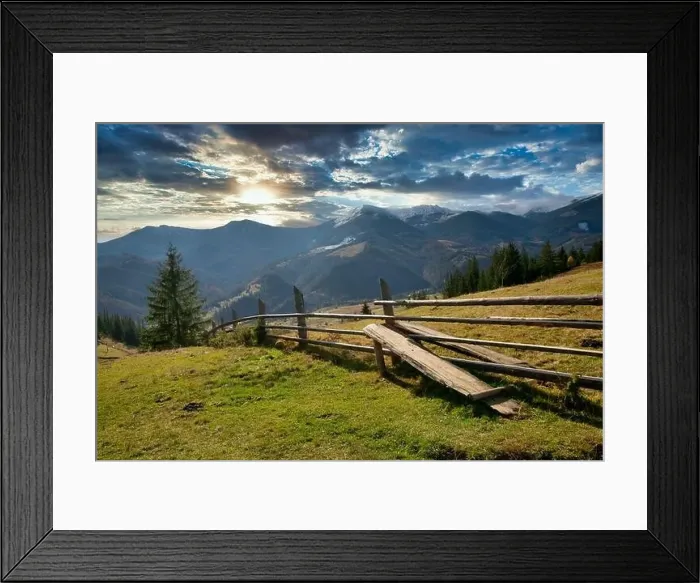 Framed Print : Bewitching beautiful summer landscape of a green meadow on a hill overlooking a dense coniferous forest Framed Print : Bewitching beautiful summer landscape of a green meadow on a hill overlooking a dense coniferous forest