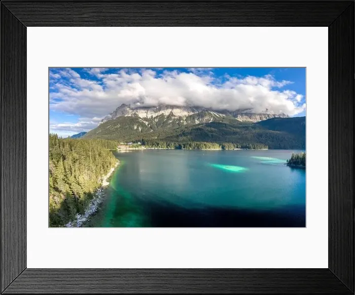 Framed Print : Aerial drone shot of Zugspitze covered with heavy fog by Eibsee Lake in Germany Framed Print : Aerial drone shot of Zugspitze covered with heavy fog by Eibsee Lake in Germany