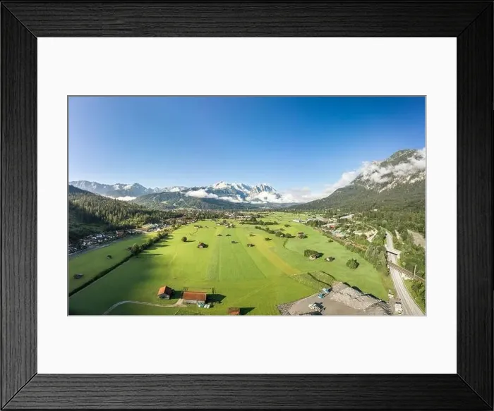 Framed Print : Aerial drone shot of village Garmisch Partenkirchen with view of Zugspitze in fog Framed Print : Aerial drone shot of village Garmisch Partenkirchen with view of Zugspitze in fog