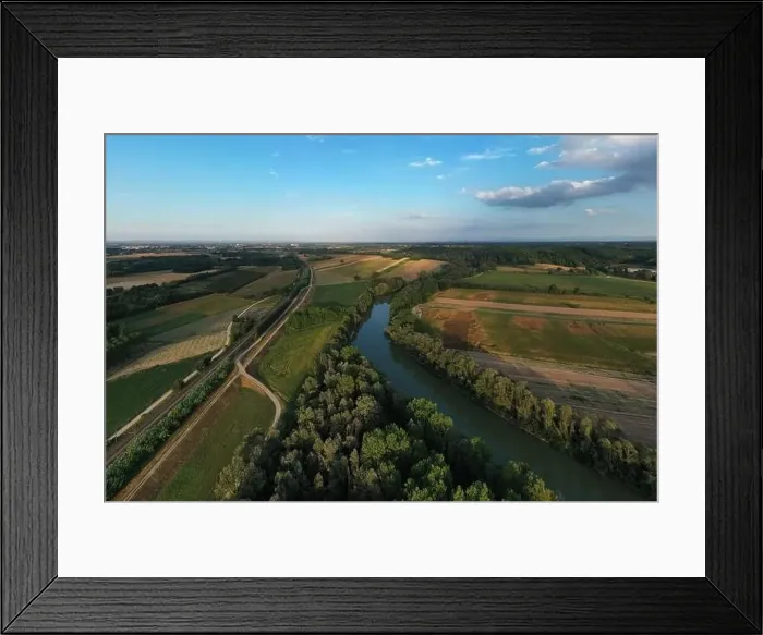 Framed Print : Aerial view of Tanaro river, vegetation and cultivated fields during a sunny afternoon in summer