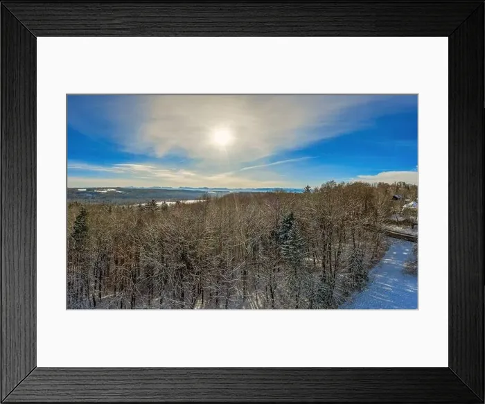 Framed Print : Sunny winter day in aerial view over the tree tops to the alp mountains in the winter background Framed Print : Sunny winter day in aerial view over the tree tops to the alp mountains in the winter background