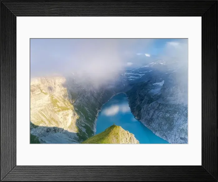 Framed Print : Hiker on mountain ridge admiring the foggy sunset over lake Limmernsee, aerial view, Canton of Glarus, Switzerland Framed Print : Hiker on mountain ridge admiring the foggy sunset over lake Limmernsee, aerial view, Canton of Glarus, Switzerland