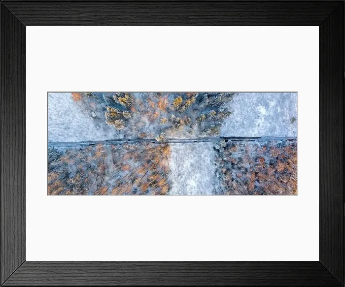 Framed Print : Track in wet ground left by logging tractor in winter forest from above Framed Print : Track in wet ground left by logging tractor in winter forest from above