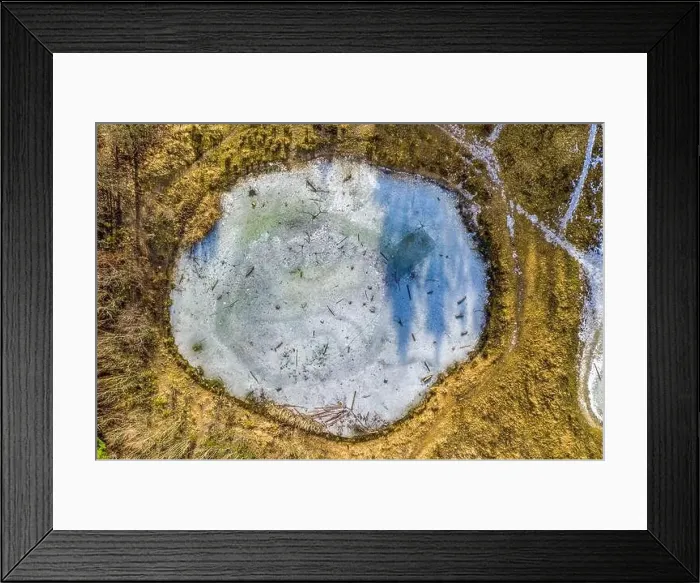 Framed Print : Round shape of a frozen lake as a top shot from a drone, looking down to a beautiful peace of a winter landscape Framed Print : Round shape of a frozen lake as a top shot from a drone, looking down to a beautiful peace of a winter landscape