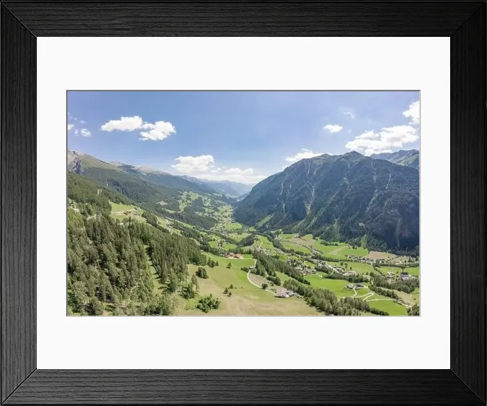 Framed Print : Aerial drone shot of Helligenblutt village in Grossglockner mountain valley in Austria Framed Print : Aerial drone shot of Helligenblutt village in Grossglockner mountain valley in Austria
