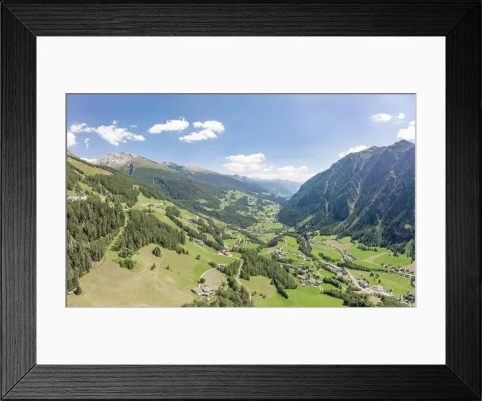 Framed Print : Aerial drone shot of Helligenblutt village in Grossglockner mountain valley in Austria Framed Print : Aerial drone shot of Helligenblutt village in Grossglockner mountain valley in Austria