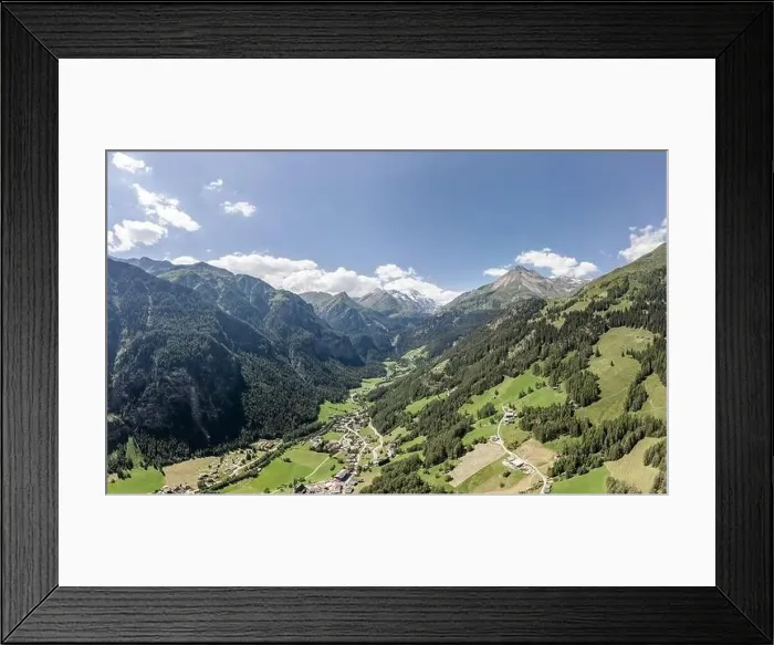 Framed Print : Aerial drone shot of Helligenblutt village in with view of Grossglockner mountain in Austria Framed Print : Aerial drone shot of Helligenblutt village in with view of Grossglockner mountain in Austria