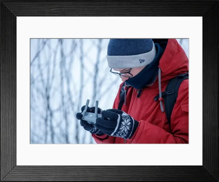 Framed Print : Russia Vyborg. 02.02.2021 A young man launches a quadcopter in winter. High quality photo Framed Print : Russia Vyborg. 02.02.2021 A young man launches a quadcopter in winter. High quality photo