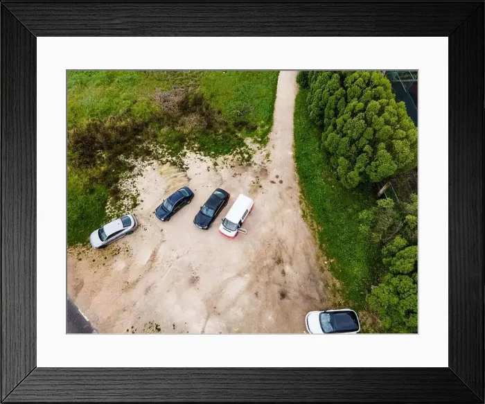 Framed Print : Aerial view of a few cars parked in a small parking lot along the road on Monsanto Hill next a football field Framed Print : Aerial view of a few cars parked in a small parking lot along the road on Monsanto Hill next a football field