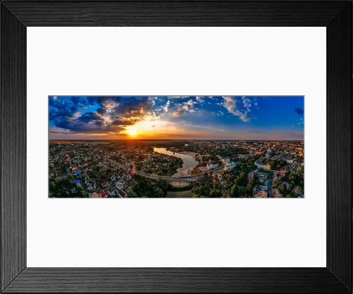 Framed Print : Aerial panoramic view of of small european city placed on river banks at summer sunny day with clouds