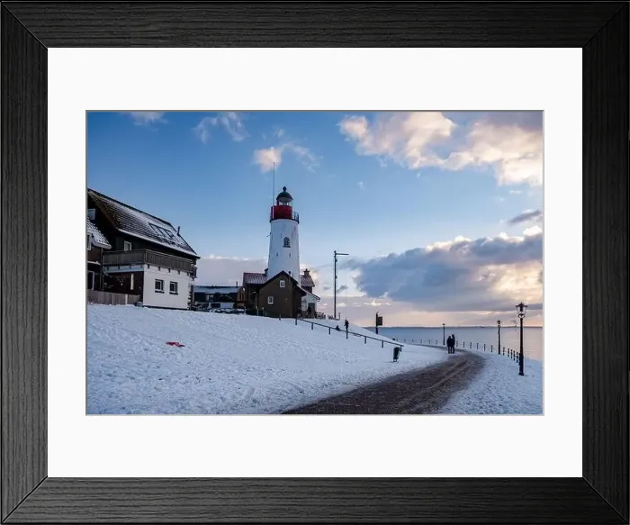 Framed Print : Urk Netherlands lighthouse during winter with snow covered coastline