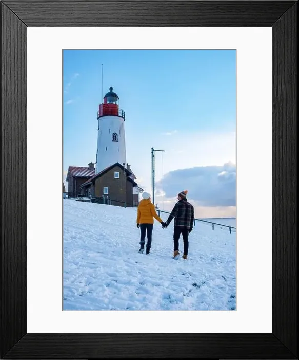 Framed Print : Urk Netherlands lighthouse during winter with snow covered coastline Framed Print : Urk Netherlands lighthouse during winter with snow covered coastline