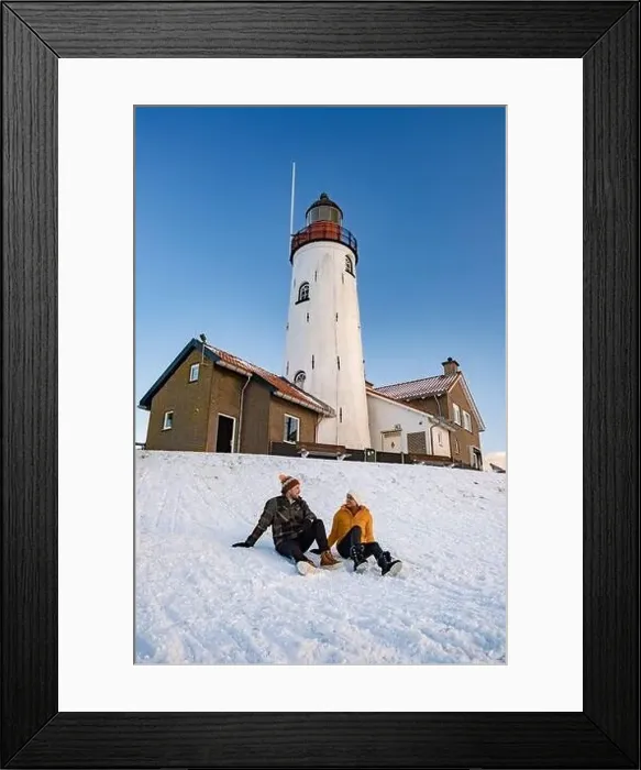 Framed Print : Urk Netherlands lighthouse during winter with snow covered coastline Framed Print : Urk Netherlands lighthouse during winter with snow covered coastline