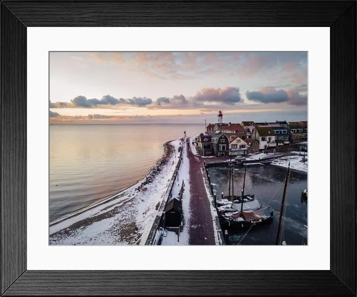 Framed Print : Urk Netherlands lighthouse during winter with snow covered coastline