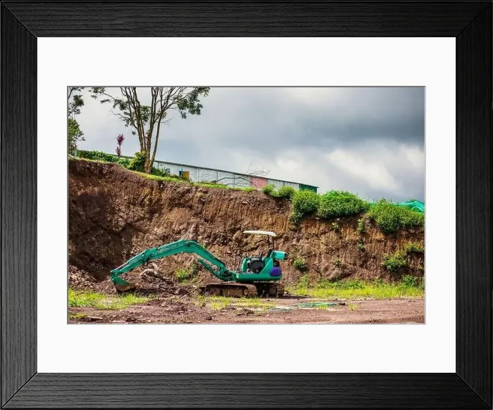Framed Print : Mini excavator is on the ground at site construction Framed Print : Mini excavator is on the ground at site construction