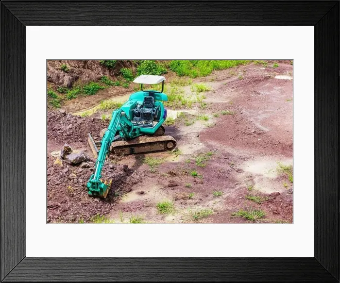 Framed Print : Mini excavator is on the ground at site construction Framed Print : Mini excavator is on the ground at site construction