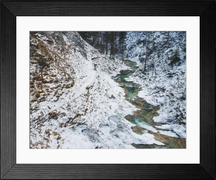 Framed Print : Aerial drone shot of snowy and icy winter landscape in the oetschergraeben Framed Print : Aerial drone shot of snowy and icy winter landscape in the oetschergraeben