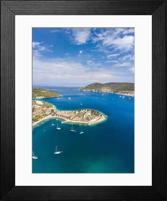 Framed Print : Aerial drone shot of St. Jeronima church on Vis Island coastline by adriatic sea in summer Framed Print : Aerial drone shot of St. Jeronima church on Vis Island coastline by adriatic sea in summer