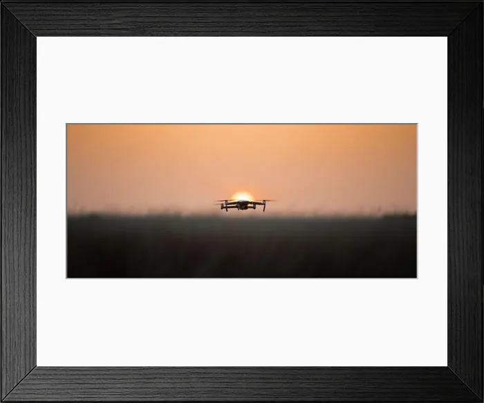 Framed Print : Drone quadcopter with digital camera in flight at sunset, Silhouette of drone at sunset Framed Print : Drone quadcopter with digital camera in flight at sunset, Silhouette of drone at sunset