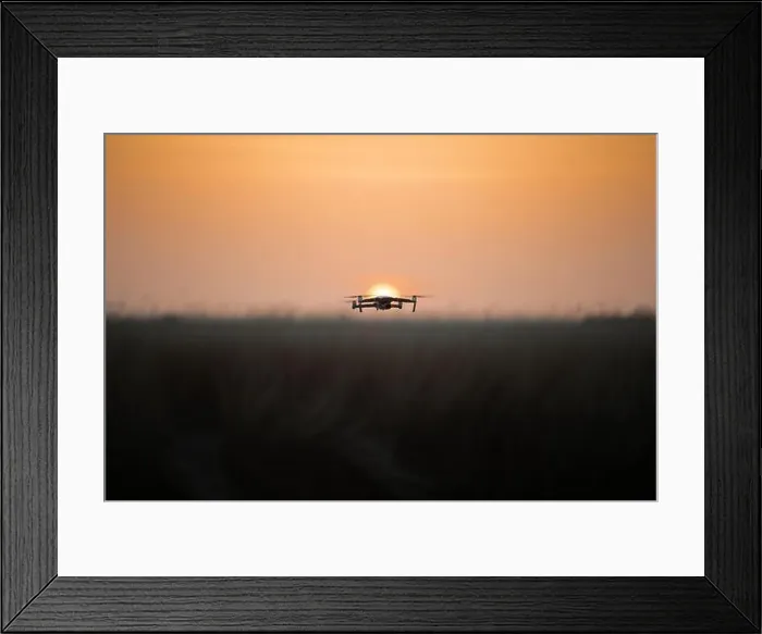 Framed Print : Drone quadcopter with digital camera in flight at sunset, Silhouette of drone at sunset Framed Print : Drone quadcopter with digital camera in flight at sunset, Silhouette of drone at sunset